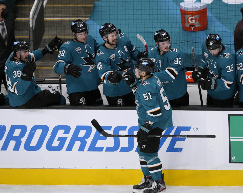 San Jose Sharks defenseman Radim Simek (51) is congratulated by teammates after scoring a goal against the Minnesota Wild during the first period of an NHL hockey game in San Jose, Calif., Monday, March 29, 2021. (AP Photo/Tony Avelar)