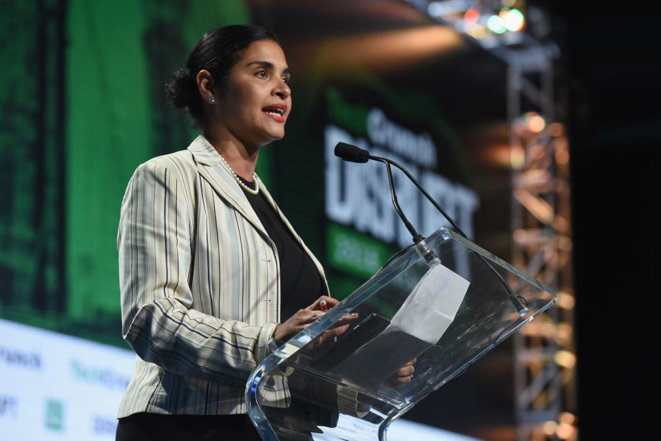 Diana Reyna speaks onstage at an event.