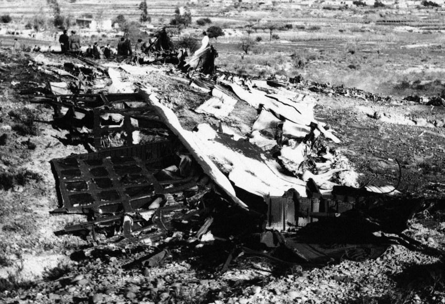 The wreckage of a USAF Jet tanker which collided Spanish officials in background search for bodies in Almeria, Spain on Jan. 18, 1966. (AP Photo)