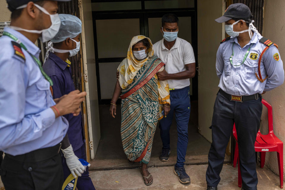 Jenima Mondal, center, whose son Mamjur Ali Mondal died in Friday's train accident is helped by a health worker after she identified the body at the All India Institute of Medical Sciences hospital in Bhubaneswar in the eastern state of Orissa, India, Monday, June 5, 2023. Families of the victims of India's deadliest train crash in decades filled the hospital on Monday to identify and collect bodies of relatives, as railway officials recommended the country's premier criminal investigating agency to probe the crash that killed 275 people. (AP Photo/Rafiq Maqbool)