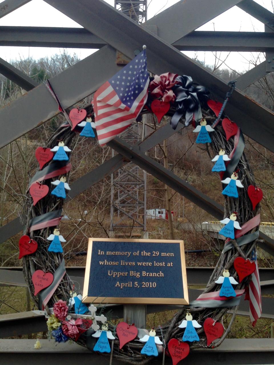 FILE - In this Dec. 3, 2015 file photo, a memorial to 29 miners killed in an April 2010 explosion is shown at the entrance to the Upper Big Branch mine in Montcoal, W.Va. A public service scheduled for Sunday, April 5, 2020, at a memorial in Whitesville, W.Va., on the 10-year anniversary of the disaster was canceled due to concerns over the coronavirus pandemic. (AP Photo/John Raby, File)