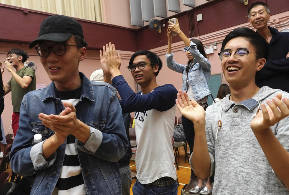 Supporters of a pro-democracy candidate cheer after winning their seat in district council elections in Hong Kong, early Monday, Nov. 25, 2019. Vote counting was underway in Hong Kong on Sunday after a massive turnout in district council elections seen as a barometer of public support for pro-democracy protests that have rocked the semi-autonomous Chinese territory for more than five months. (AP Photo/Vincent Yu)