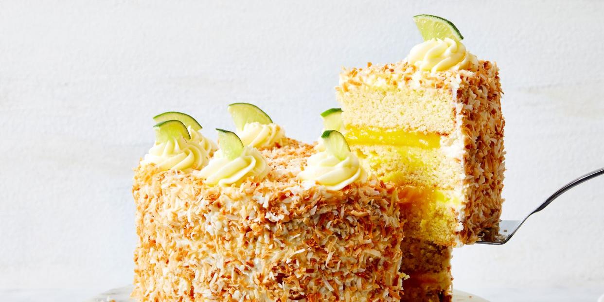 a layered coconut cake filled with lime curd and covered with toasted coconut