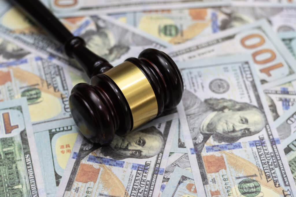 Money and hammer, wooden gavel and dollar banknotes. (Krisanapong Detraphiphat/Getty Images)