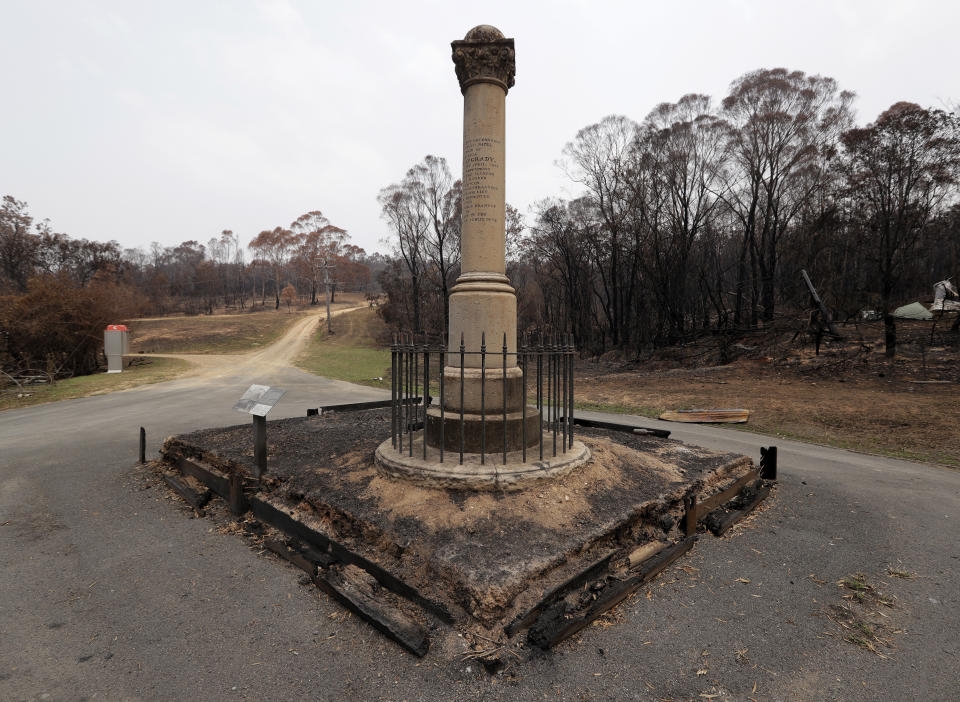 A cenotaph, commemorating a police officer who was shot and killed by outlaws, known as bush rangers, in 1866, survives at Nerrigundah, Australia, Monday, Jan. 13, 2020, after a wildfire ripped through the town on New Year's Eve. The tiny village of Nerrigundah in New South Wales has been among the hardest hit by Australia's devastating wildfires, with about two thirds of the homes destroyed and a 71-year-old man killed. (AP Photo/Rick Rycroft)