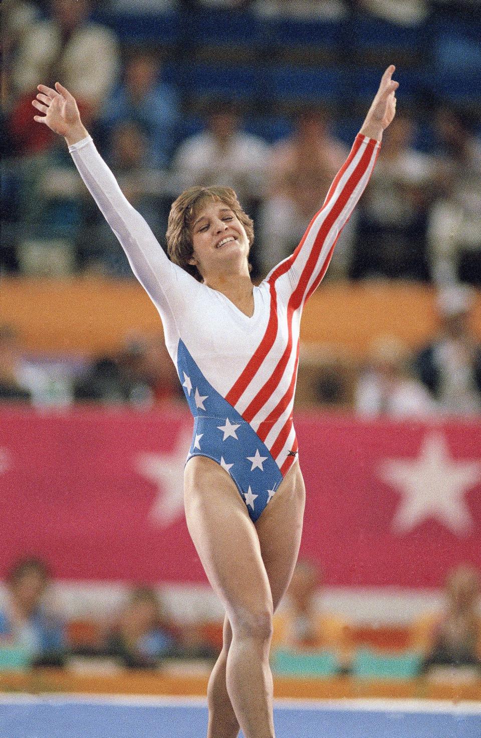 FILE - In this 1984 file photo, Mary Lou Retton celebrates her balance beam score at the 1984 Olympic Games in Los Angeles. (AP Photo/Lionel Cironneau, File)