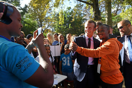 FILE PHOTO: French President Emmanuel Macron poses for a selfie as visitors are allowed access to the Elysee Palace in Paris, France, September 15, 2018, as part of France's Heritage Days. Anne-Christine Poujoulat/Pool via REUTERS/File Photo