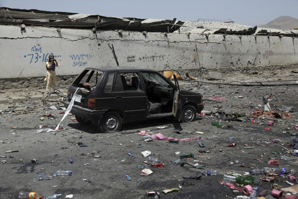 A damaged civilian car is seen at the site of a suicide attack in Kabul, Afghanistan, Thursday, July 25, 2019. Three bombings struck the Afghan capital on Thursday, killing at least eight people, including five women and one child, officials said Thursday. (AP Photo/Rahmat Gul)