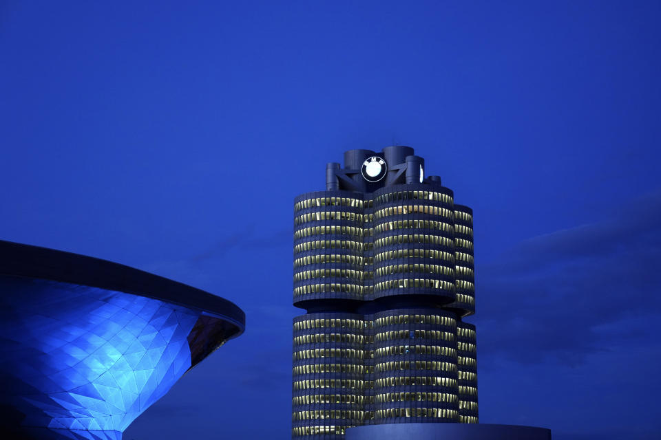 FILE-In this May 22, 2021 file photo the headquarters of German car manufacturer BMW is illuminated in Munich, Germany. German automaker Daimler on Friday dismissed a “cease and desist” demand from two environmental groups to commit to ending the sale of combustion engine vehicles by 2030. Lawyers for Greenpeace and the group Deutsche Umwelthilfe have threatened to sue Daimler, BMW and Volkswagen unless they sign a legal pledge not to put new gas-fueled vehicles onto the market from the end of this decade. (AP Photo/Matthias Schrader)