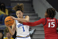 UCLA guard Kiki Rice, left, is hit in the face by Arizona guard Kailyn Gilbert during the second half of an NCAA college basketball game Friday, Feb. 3, 2023, in Los Angeles. (AP Photo/Mark J. Terrill)