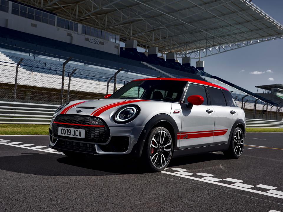 A white and red MINI car is parked on a race track.