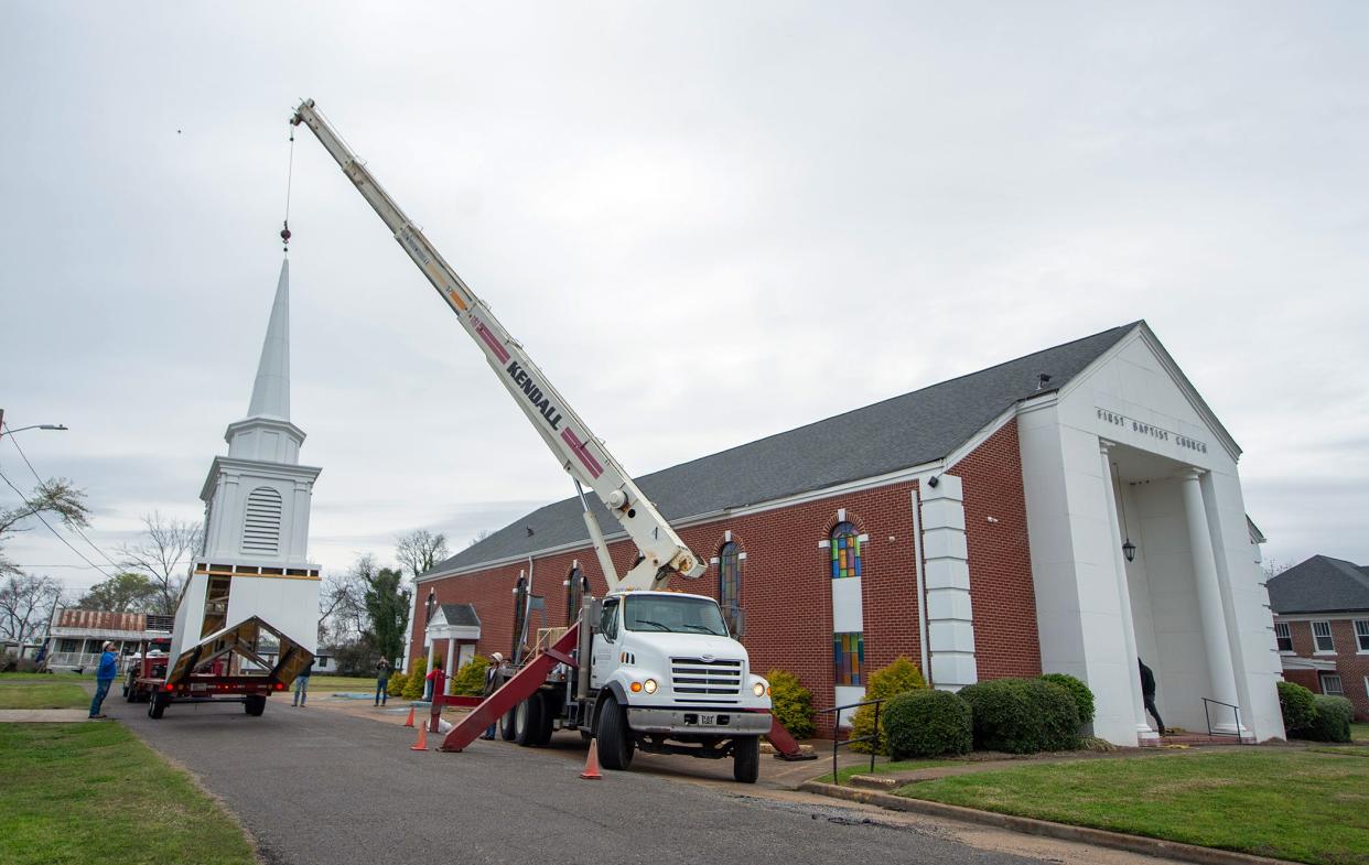 The new steeple for First Baptist Church of Rolling Fork is lifted off the flatbed truck before it was scheduled to be placed atop the church roof on Friday, two days before the anniversary of a tornado hitting the church and the town. The EF-4 tornado that ripped through the small Delta town on March 24, 2023, took down the previous steeple. The church plans to have it up and ready for Sunday. The chimes are scheduled to ring for the first time at 8:03 p.m., Sunday, one year to the minute the tornado hit.