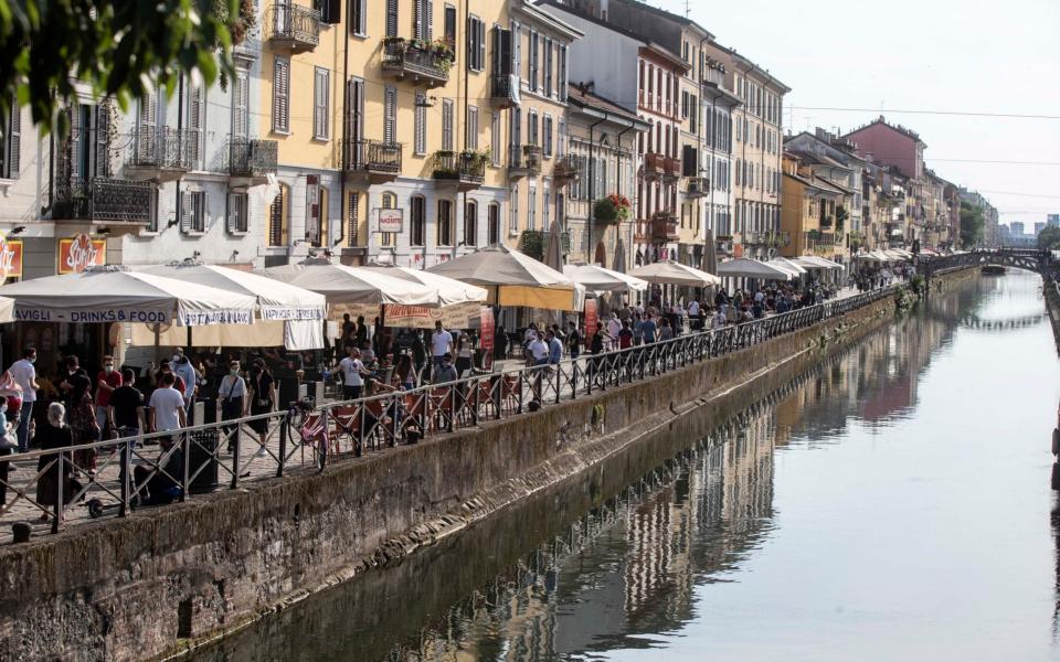 Bars and restaurants along the Naviglio Grande canal in Milan - AP