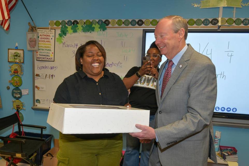 Muscogee County School District superintendent David Lewis surprises Nicole Hodge of Britt David Magnet Academy in her classroom March 14, 2024, with a cake celebrating the announcement that she is among the three finalists for MCSD’s Teacher of the Year award.