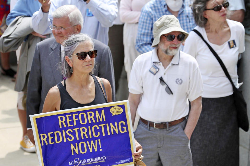 FILE - People listen to speakers during the Redistricting Reform Rally at the Indiana Statehouse in Indianapolis, Aug. 11, 2021. (Kelly Wilkinson/The Indianapolis Star via AP, File)