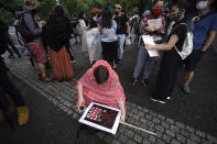 A protester prepares a banner prior to a solidarity rally for the death of George Floyd in Tokyo Sunday, June 14, 2020. Floyd died after being restrained by Minneapolis police officers on May 25. (AP Photo/Eugene Hoshiko)