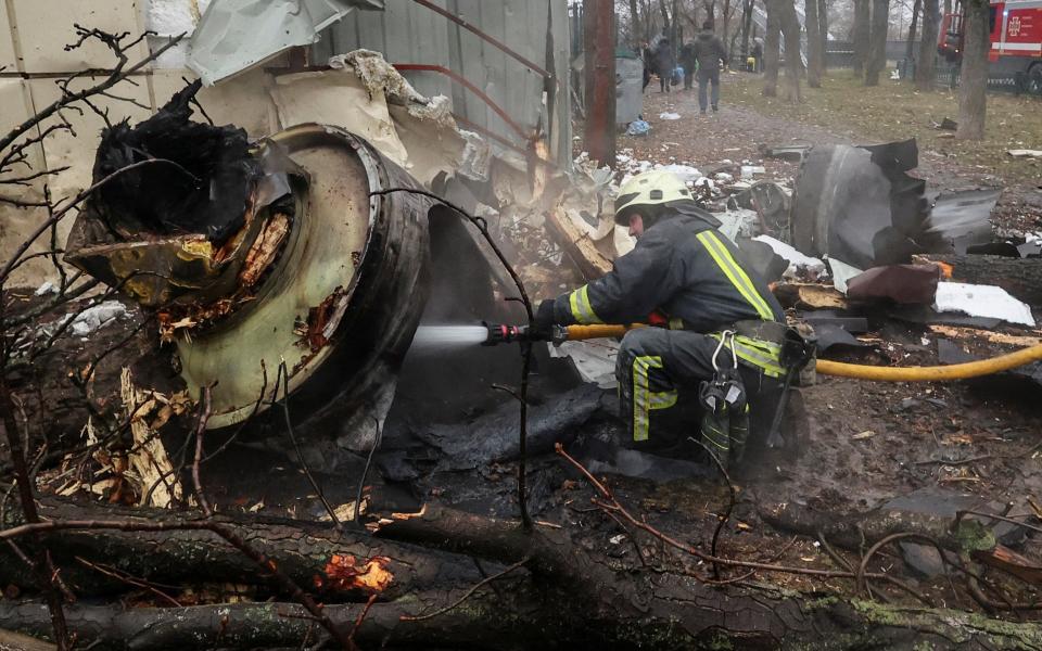 A firefighter extinguishes remains of a missile, which Ukraine claims to be made in North Korea, amid Russia's attack in Kharkiv,