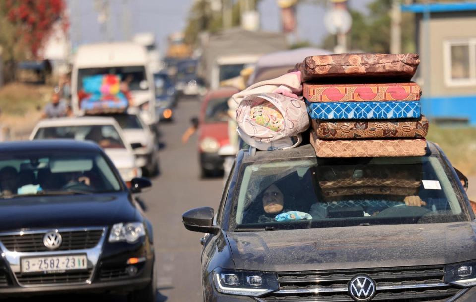 Palestinian families with their belongings flee following the Israeli army's warning to leave their homes (AFP via Getty Images)