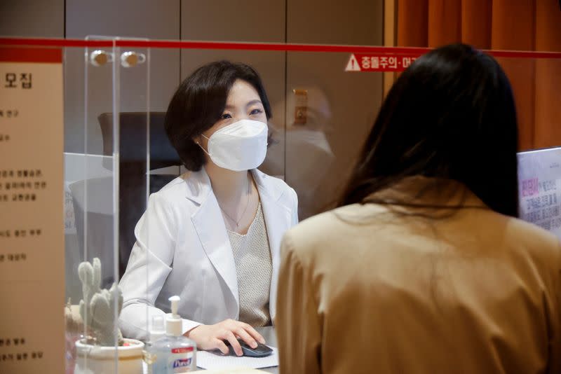 Kim Ji-hyun, a professor at Cha Fertility Center, checks a patient at the clinic, in Bundang