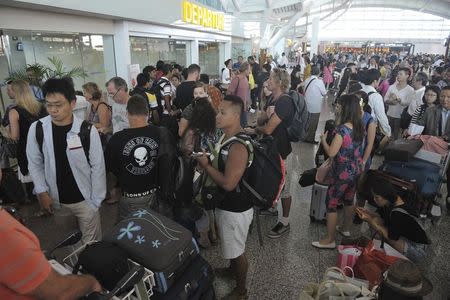 Passengers wait in the international terminal at Ngurah Rai Airport on the Indonesian resort island of Bali July 10, 2015 in this photo taken by Antara Foto. REUTERS/Nyoman Budhiana/Antara Foto