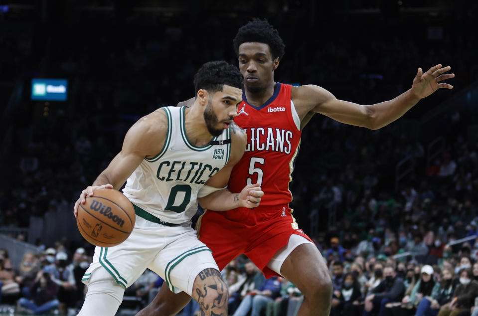 Boston Celtics forward Jayson Tatum (0) drives against New Orleans Pelicans forward Herbert Jones (5) during the second half of an NBA basketball game, Monday, Jan. 17, 2022, in Boston. (AP Photo/Mary Schwalm)