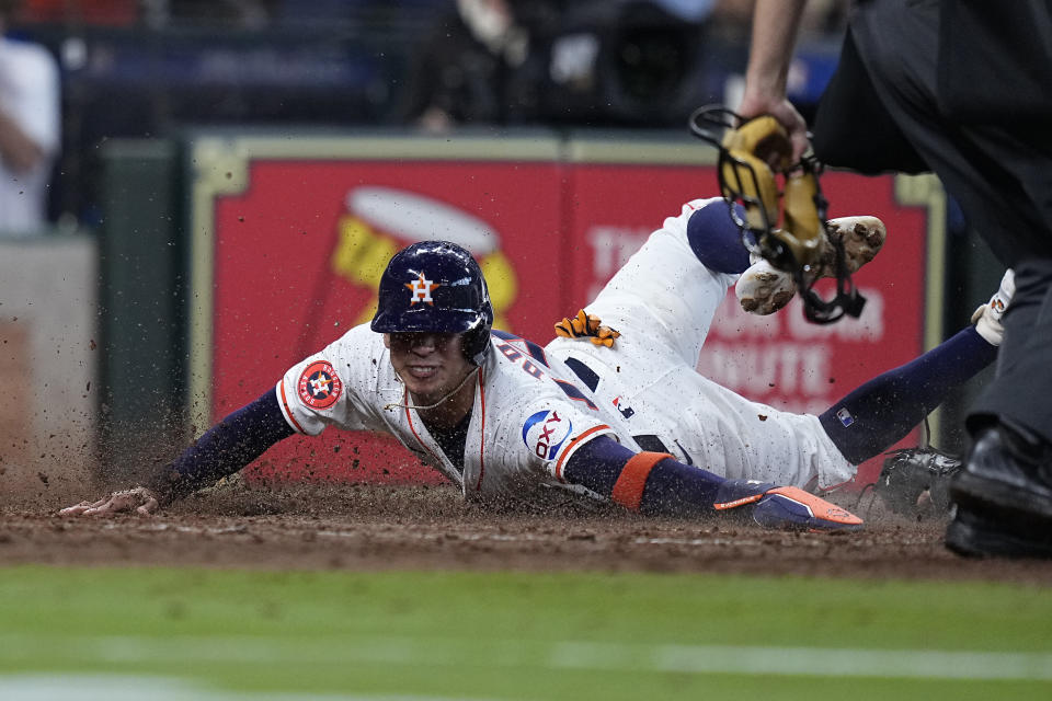 Houston Astros' Mauricio Dubon is tagged out at the plate by New York Yankees catcher Jose Trevino during the ninth inning of a baseball game, Thursday, March 28, 2024, in Houston. (AP Photo/Kevin M. Cox)