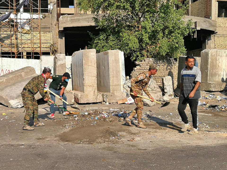 Security forces clean up the protest sites near Tahrir square during anti-government ongoing protests in Baghdad, Iraq, Friday, Nov. 1, 2019. (AP Photo/Khalid Mohammed)