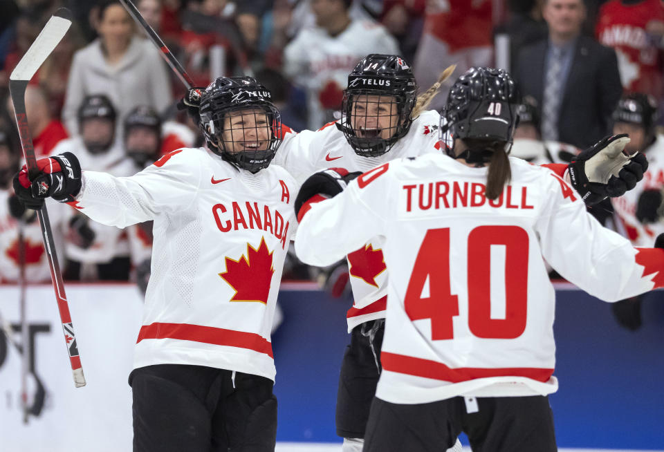 Canada forward Blayre Turnbull (40) and defender Renata Fast (14) congratulate defender Jocelyne Larocque (3) on her goal against Czechia during the second period of a women’s world hockey championships game Friday, April 7, 2023, in Brampton, Ontario. (Frank Gunn/The Canadian Press via AP)