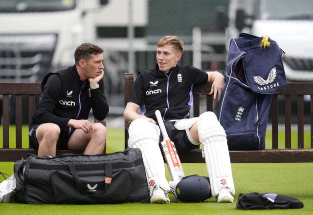 Dan Lawrence (left) chats to a padded up Zak Crawley (right) at England nets.