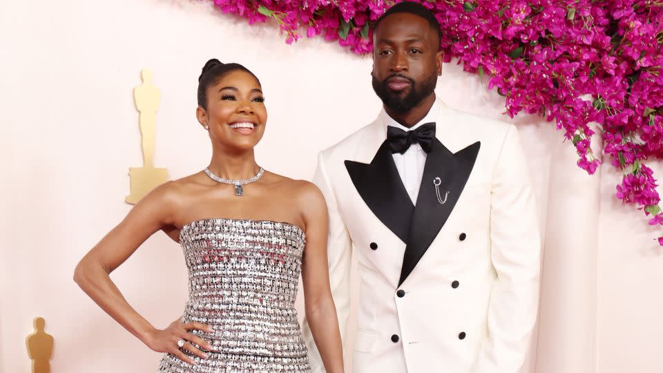 Gabrielle Union, pictured with husband Dwyane Wade (in custom Atelier Versace), turned heads in a bedazzled Carolina Herrera gown layered with a matching floor-length skirt. She completed the look with a diamond necklace from Tiffany & Co. - Kevin Mazur/Getty Images