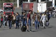 FILE - A group of Russians walk after crossing the border at Verkhny Lars between Georgia and Russia in Georgia, on Sept. 27, 2022. Long lines of vehicles have formed at a border crossing between Russia's North Ossetia region and Georgia after Moscow announced a partial military mobilization. (AP Photo/Zurab Tsertsvadze, File)