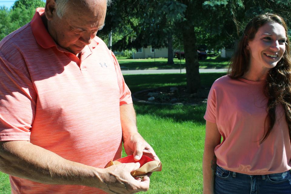 Jim Pappas, a 1970 graduate of Sturgis High School, looks at his 1968 hunting license found by Ashley Brewer, current owner of the 1969-70 SHS building trades house.