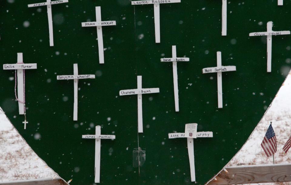 Snowflakes float over part of a memorial for the victims of the Sandy Hook Elementary School shooting in Newtown