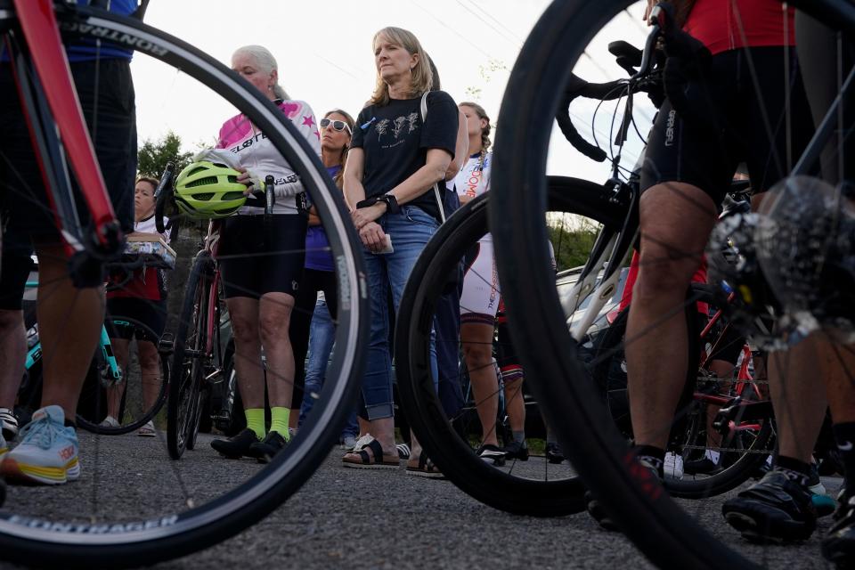 Kim Milligan, center, listens as a group of cyclists gather to remember her daughter, Alyssa, before a memorial ride in her honor Tuesday, Sept. 12, 2023, in Mount Juliet, Tenn. Milligan's daughter was struck and killed by a pickup truck while cycling with a friend the previous week.