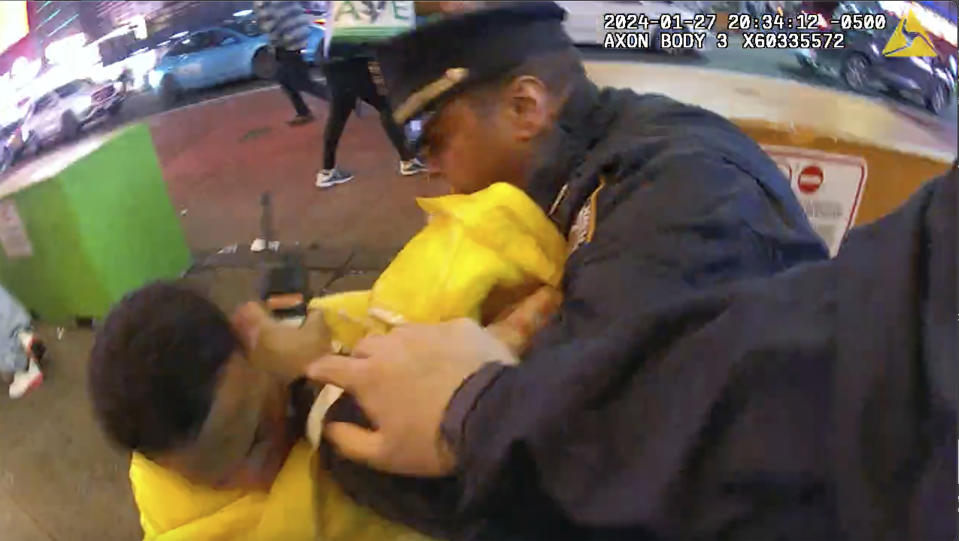 This image from body cam video provided by the Office of the Manhattan District Attorney, Thursday, Feb. 8, 2024, shows the brawl between New York City Police Department officers and migrants in Times Square, Jan. 27, 2024. Manhattan D.A. Alvin Bragg announced six additional indictments of men allegedly involved in a brawl with police officers in Times Square, but he said investigators were still working to identify several suspects and their exact role in the frenzy. (Manhattan District Attorney via AP)