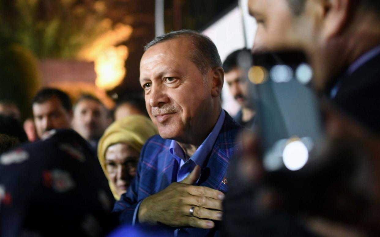 Turkish president Recep Tayyip Erdogan acknowledges supporters during a rally - AFP