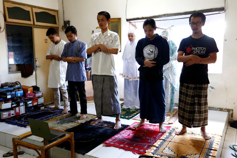 Indonesian Muslims take part in prayers during Eid al-Fitr, the Muslim festival marking the end the holy fasting month of Ramadan, at a boarding house amid the spread of coronavirus disease (COVID-19) outbreak