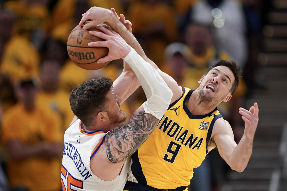 INDIANAPOLIS, IN - MAY 17: Indiana Pacers' No. 9 during the third quarter of Game 6 of the Eastern Conference Second Round Playoffs at Gainbridge Fieldhouse on May 17, 2024. TJ McConnell goes up against No. 55 Isaiah Hartenstein of the New York Knicks for a rebound. Located in Indianapolis, Indiana. NOTE TO USER: You expressly acknowledge and agree that by downloading or using this photo, you are agreeing to the terms of the Getty Images License Agreement.  (Photo by Dylan Buell/Getty Images)