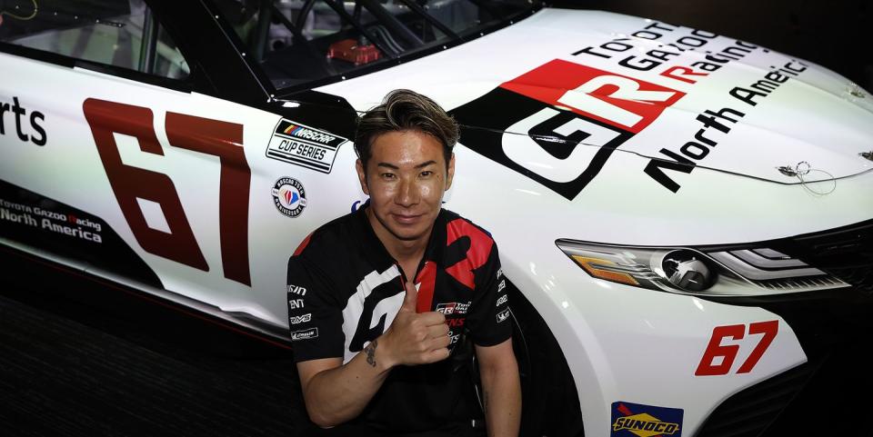 le mans, france june 07 kamui kobayashi of japan poses next to the 67 toyota camry trd car he will drive at indianapolis motor speedway later this year in a press conference ahead of the 100th anniversary of the 24 hours of le mans at the circuit de la sarthe june 7, 2023 in le mans, france photo by chris graythengetty images