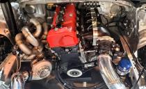 <p>This is a peek under the hood of a 926-hp Honda Civic Si. The engine is turned longitudinally and transforms a front-wheel-drive coupe into a rear-wheel-drive drift-spec machine. The work was done with help from Jeanneret Racing and Olson Kustom Works.</p>