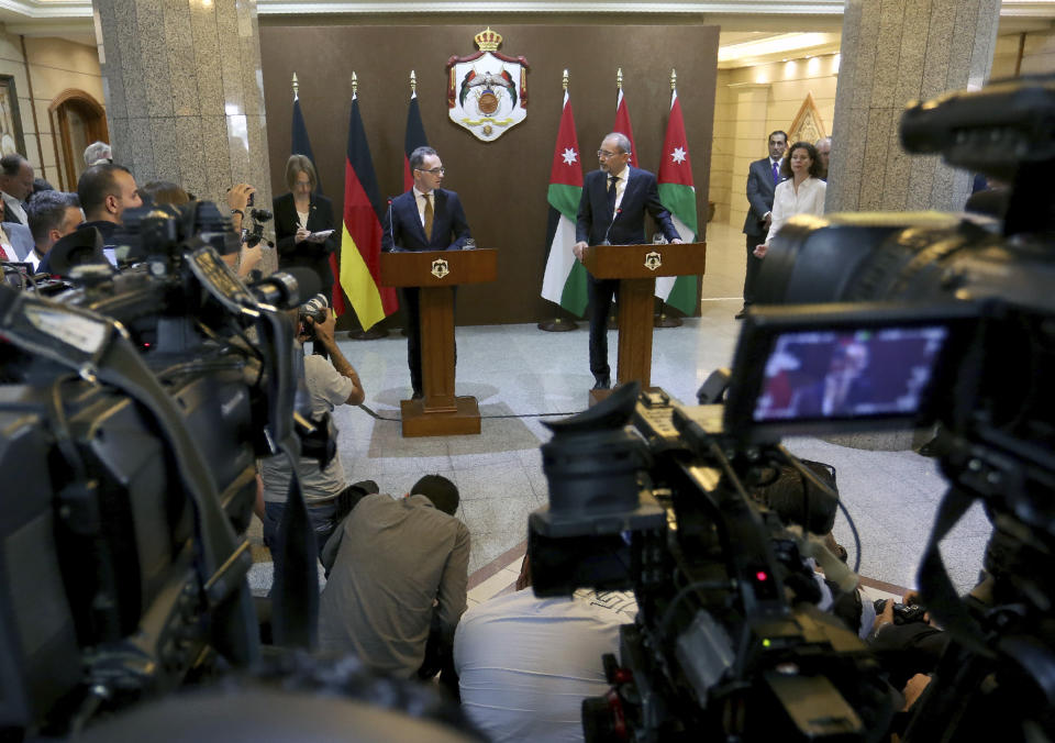 German Foreign Minister Heiko Maas, left, and Jordanian Foreign Minister Ayman Safadi, deliver statements to the press in Amman, Jordan, Sunday, June 9, 2019. In a statement on Saturday, Maas's office said European nations must engage with the Middle East at a time of heightened concern following recent U.S. naval movements in the Persian Gulf. (AP Photo/Raad Adayleh)