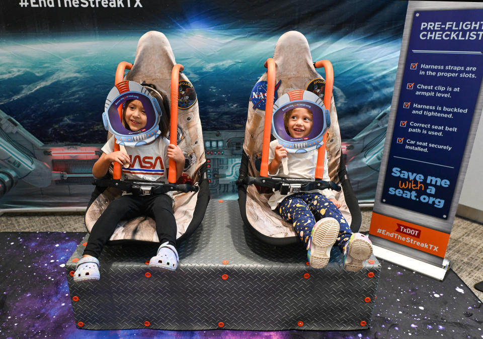 Aurora, 4, left, and her sister Reina Arredondo, 3, try out the interactive space exhibit during the opening of National Child Passenger Safety Week with the Texas Department of Transportation (TxDOT) at University Health Women's & Children's Hospital in San Antonio. The National Highway Traffic Safety Administration says nearly half of all child safety seats in cars are installed incorrectly. The campaign aims to encourage parents to have their child safety seats checked.