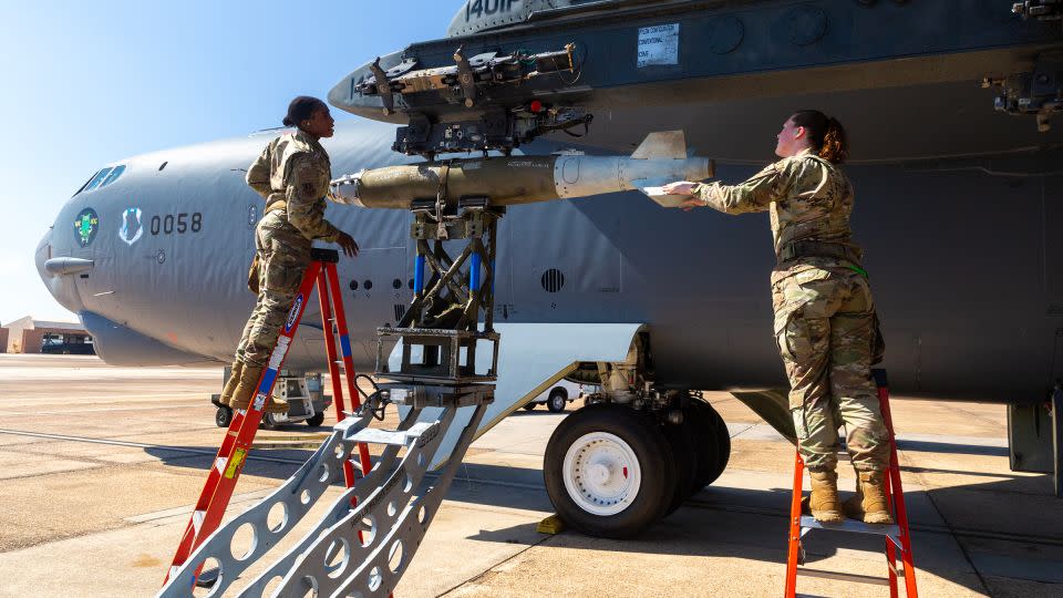 Staff Sgt. Dakeeja Nelson, left, and Senior Airman Veruca Plott, right, check that a precision 500 pound bomb has been properly loaded on the underwing bomb rack of a B-52H. - Oren Liebermann/CNN