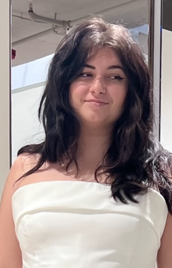 Young woman in a white strapless wedding dress, smiling slightly