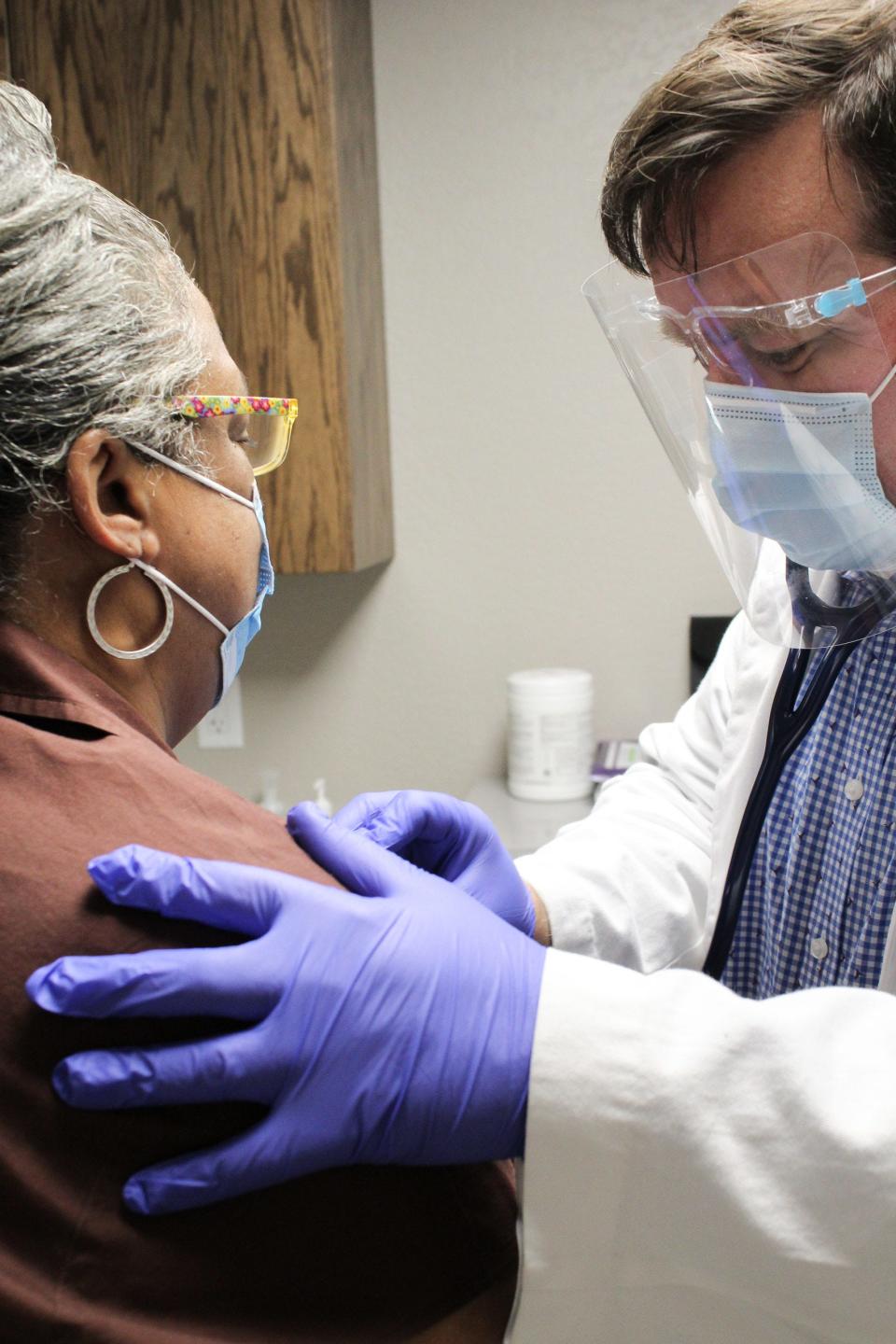 Dr. Daniel Joyce examines a patient at Hearts That Care Volunteer Health Clinic. Hearts That Care received a $10,000 grant through Gannett's A Community Thrives initiative.