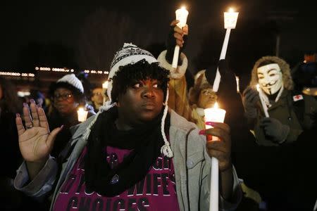 Protesters gather for candle light vigil, protesting over the August 9 police shooting of Michael Brown, outside the Ferguson Police Department in Ferguson, Missouri, November 21, 2014. REUTERS/Jim Young