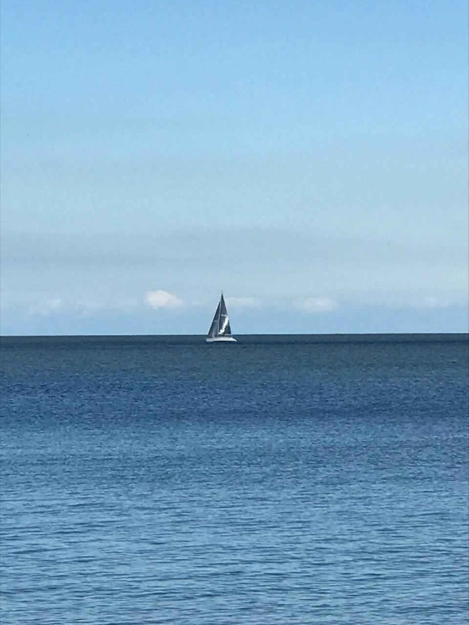 Come sail away. A lone sailboat crosses a calm Lake Erie. Provided by Jim Laroy