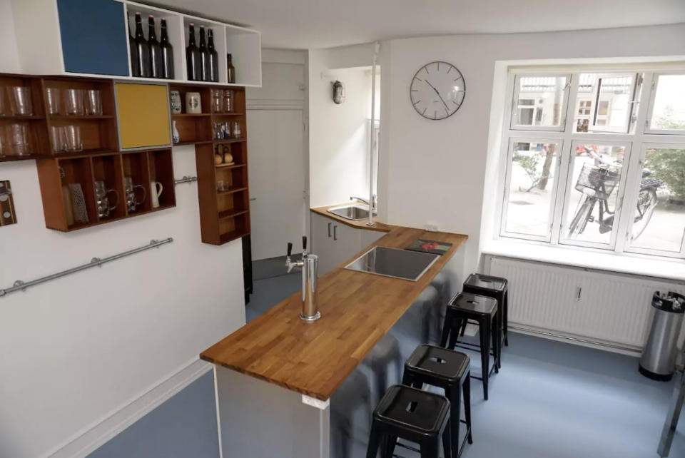 <p>If you’re looking for a more urban beer vacation, this B&B (Bed and Beer) in Copenhagen, Denmark that costs $176 a night could be right for you. The fully stocked kitchen and bar counter are seen here. (Airbnb) </p>