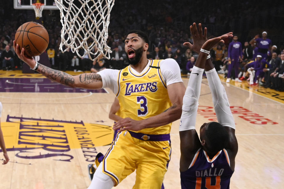 Los Angeles Lakers forward Anthony Davis, left, shoots as Phoenix Suns forward Cheick Diallo defends during the first half of an NBA basketball game Monday, Feb. 10, 2020, in Los Angeles. (AP Photo/Mark J. Terrill)