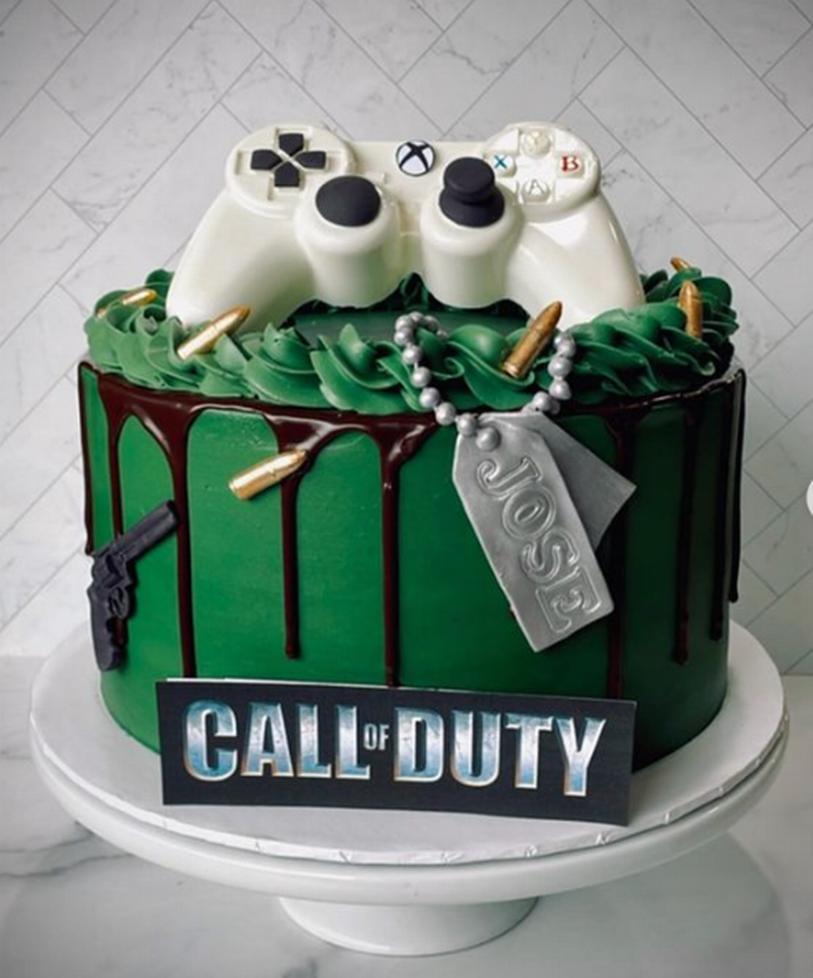 Call of Duty themed coconut cake from Simply Sweetz LLC featuring a white chocolate Xbox controller. Courtesy: @simplysweetz_llc Instagram
